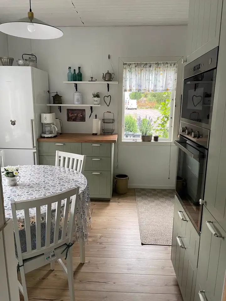 Küche mit Essplatz, Kühlschrank und Backofen